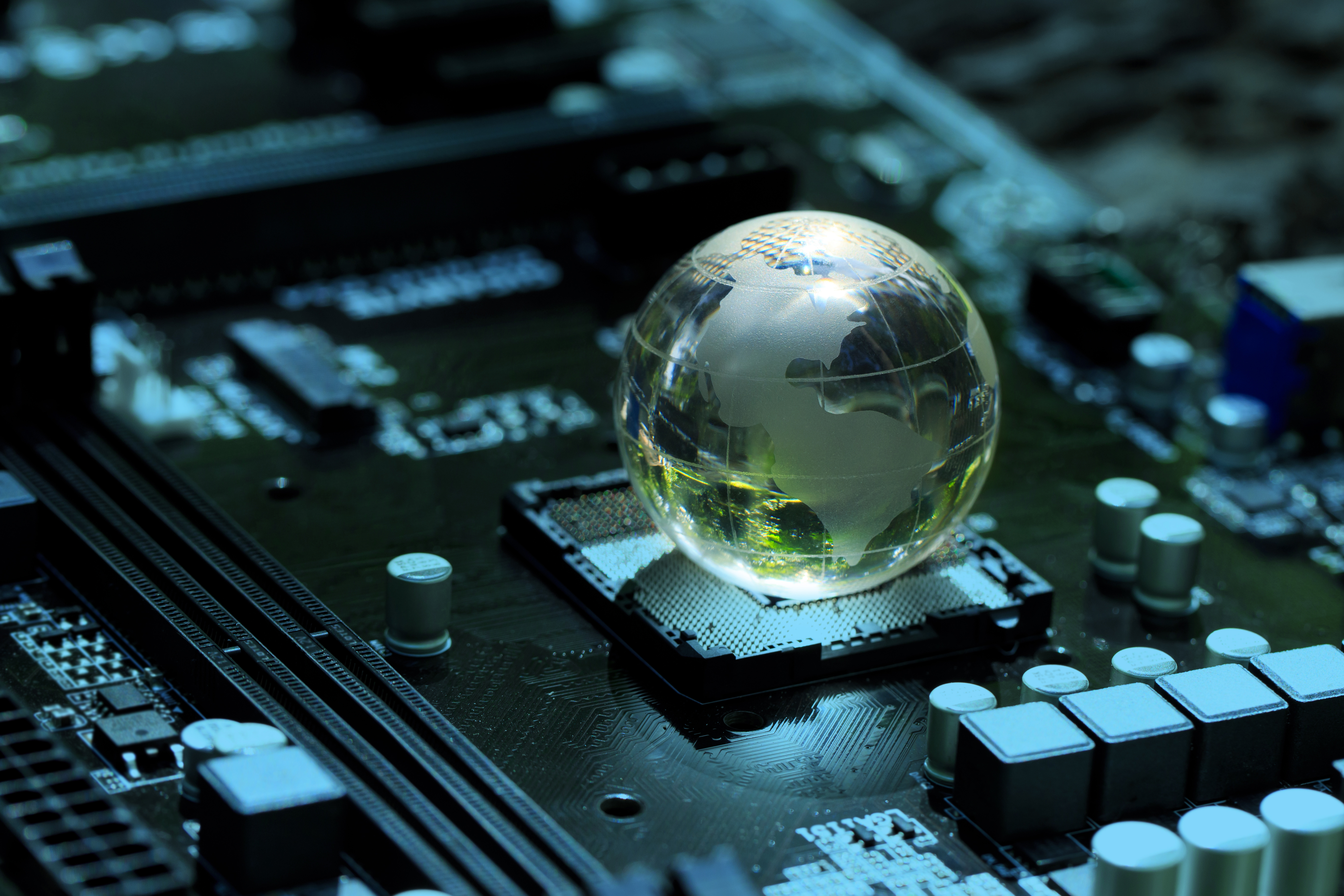 ALT Text: a Green globe with the inside of a computer  