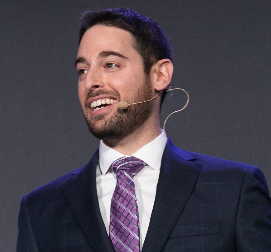 ALT Text: Headshot image of Steven Hummel in a suit and purple tie 