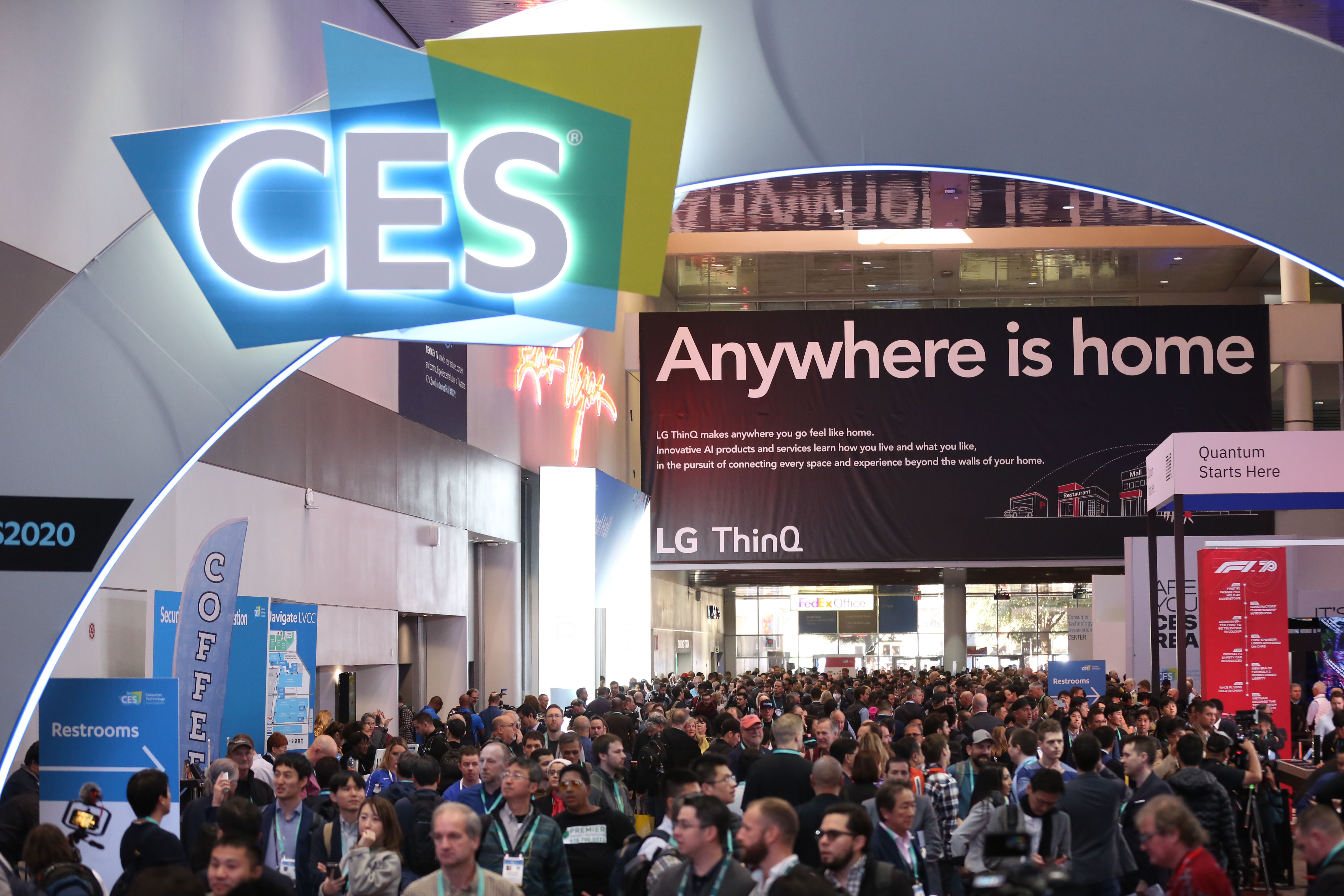 ALT Text:A possible short ALT text for this image could be:  Large crowd gathered at CES under an archway with the CES logo