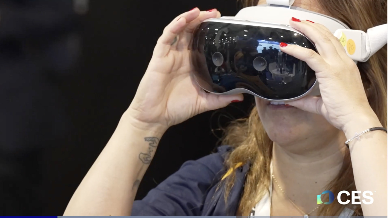 ALT Text: a women looking through a virtual reality headset