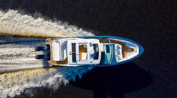 ALT Text: a Large boat driving in the water fast